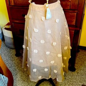 Ladies linen skirt with cream puff balls.